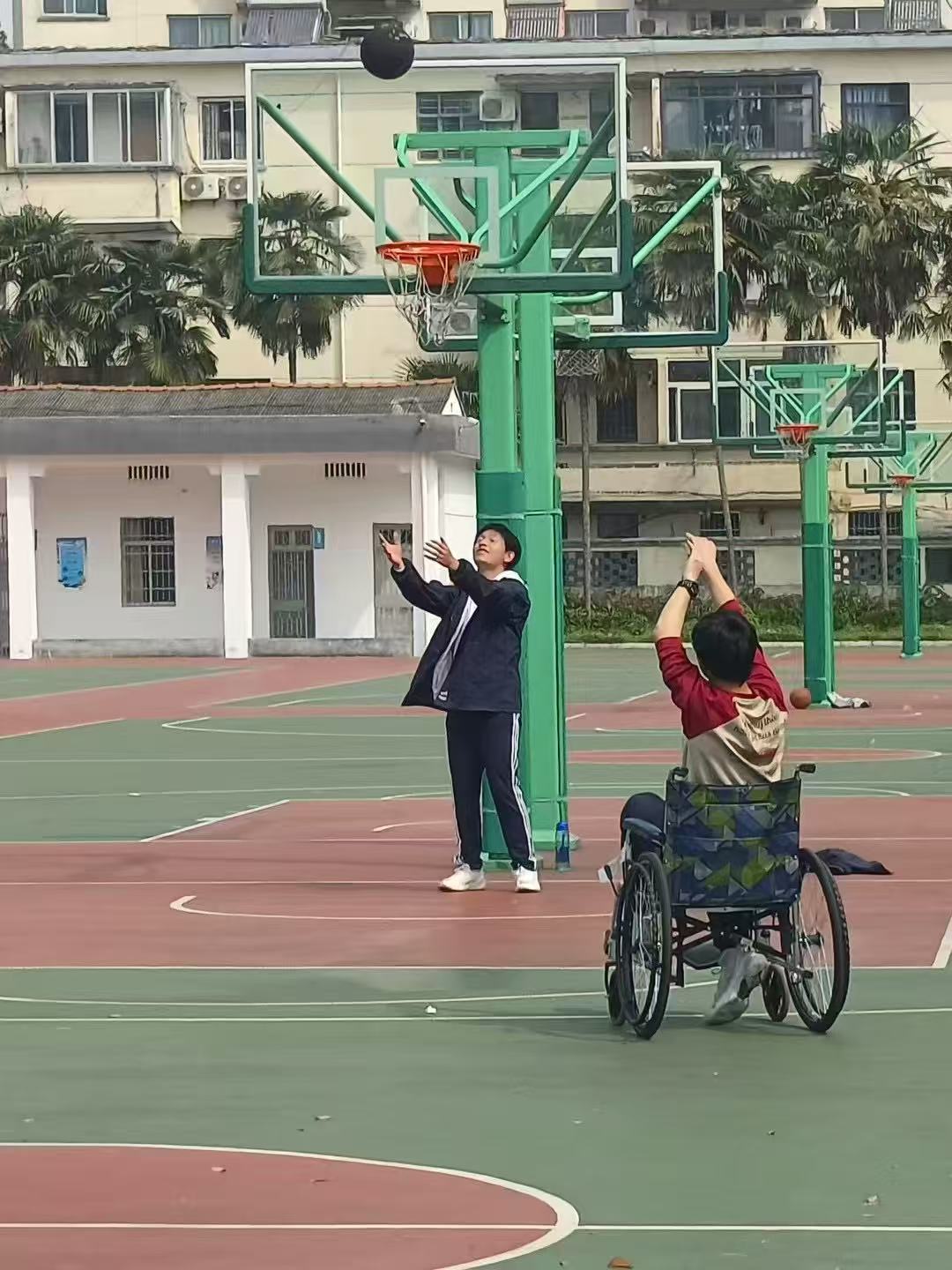 People watching a basketball shot on an outdoor court