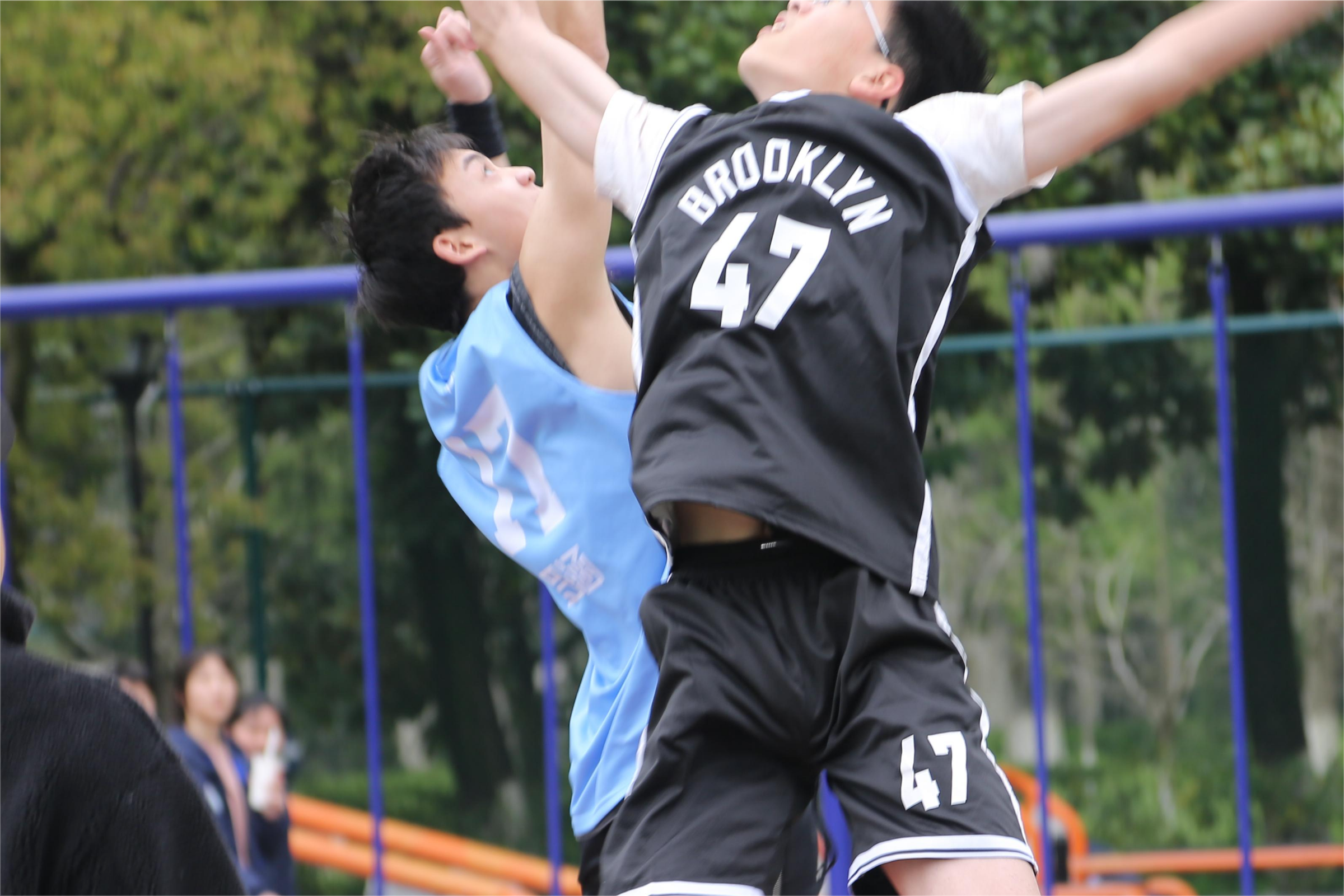 Two basketball players contesting a rebound